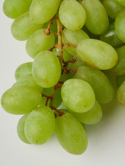 Fresh green grapes with leaves. Isolated on white. stock photo