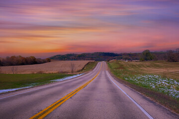 Empty asphalt road in rural landscape at sunset , USA 