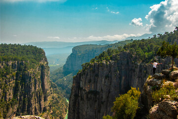 Magnificent view of Tazi Canyon in Koprulu Nature Park in Turkey and man standing on top of majestic cliff. View of the valley from above. Manavgat, Antalya.