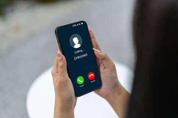 Human use smartphone with incoming call from unknown number, spam, prank caller, hoax person, fake...