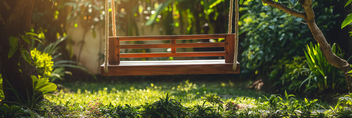 A wooden swing hung by ropes from tree branches, basked in the warm glow of the sunrise amidst a tranquil garden