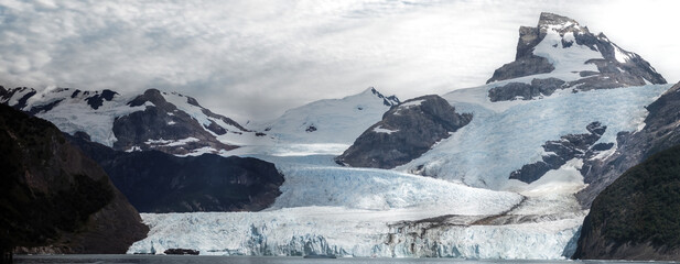 Majestic Glacier View with Snowy Peaks and Cloudy Sky