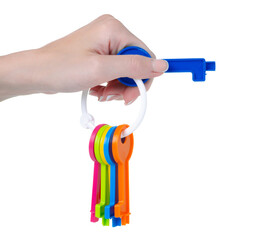 children's toy keys in hand on white background isolation