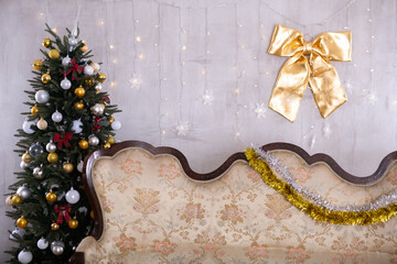 New Year Eve in room with a sofa and different gift boxes on it and big decorated Christmas tree next to it - 800246548