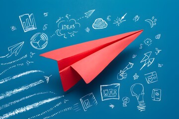 Red paper airplane flies among hand drawn symbols, symbolizing innovation and ideas taking flight on blue background