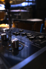 Close-up of a professional music mixer in the studio, selective focus. Vertical photo