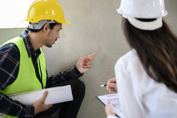 Female civil engineer with inspection check sheet consult with construction site foreman technician...