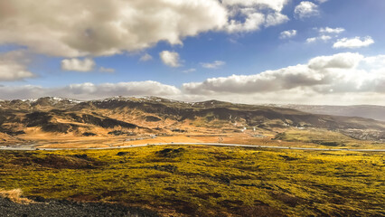 Iceland, aerial panorama of a magnificent view from the height of the slope. The sky and mountains are beautiful, the landscapes of spring Iceland.