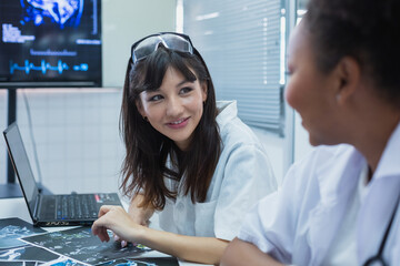 Female medical student study in class room. medical students studying human brain disease diagnosis through learning from X-ray film. Learn about brain surgery for diagnosis.