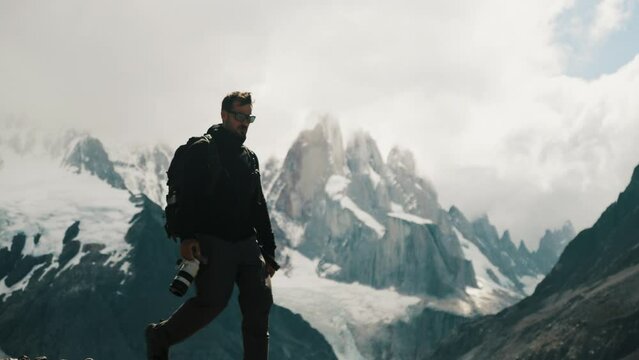 Travel Photographer Walking On Cerro Torre Mountain Trail In Santa Cruz, Argentina. slow motion shot