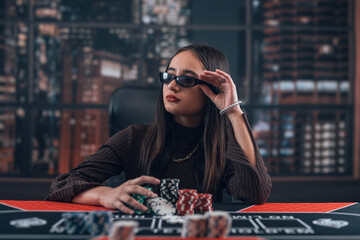 Pretty female playear play in Texas Hold'em poker and win  lot of chips, poker room at casino