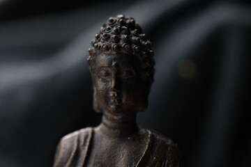 Closeup of a small statue of Buddha.