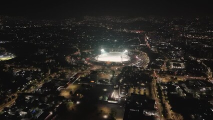 Check out the UNAM's Olympic Stadium from above, all lit up at night in Mexico City
