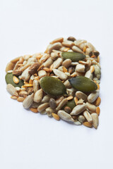 Healthly Eating Shot With Nuts And Seeds In Shape Of A Heart On White Background