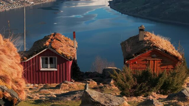 Drone reveal majestic glacier view from Norway mountainside cabins in sunset