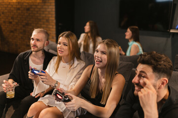 Women demonstrate level of proficiency in playing video games. Audience marvel at females ability...