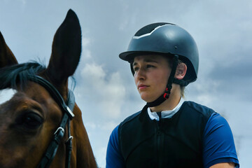 Portrait of a beautiful young woman preparing before a horse riding competition