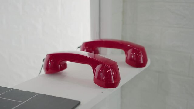 Sleek retro red telephone receivers, a callback to classic communication design