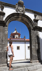 Young woman sightseeing in Viana do Castelo, view at the Misericórdia (Mercy) church, Portugal