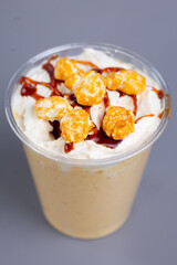 milkshake with popcorn in a plastic cup