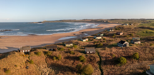 Aerial view of remote beach huts on the Northumberland coast at Embleton Bay