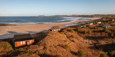 Aerial view of remote beach huts on the Northumberland coast at Embleton Bay