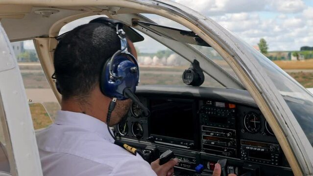 A pilot going over the checklist before takeoff