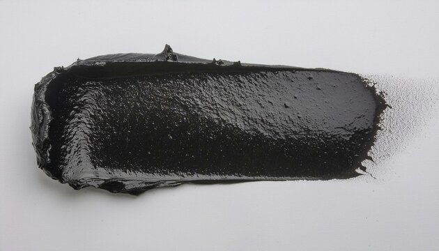 photo of wet dark lino ink remain, black linocutting paint roller texture isolated on white paper background.