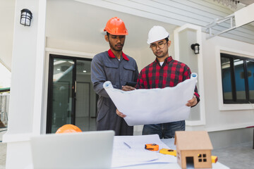 Contractor engineer discusses with an architect the construction of a home renovation project at...