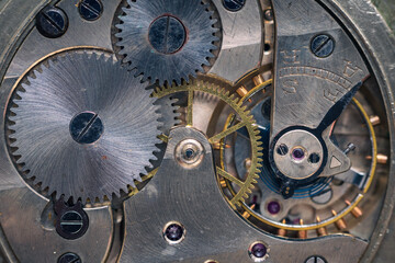 Pocket watch mechanism. Mechanical steel clockwork with cogwheel and screw