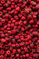 Large pile of raspberries in a flat lay top view,wallpaper style,healthy fruit concept.