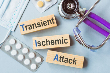 TIA or Transient Ischemic Attack Medical Concept Displayed on Wooden Blocks With Stethoscope and Medication
