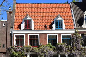 Lindengracht Street House Exterior with Red Tiled Roof and Colored Window Frames in Amsterdam, Netherlands