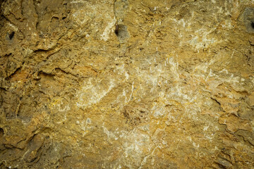Light brown rock texture. Mountain rough surface. Close-up.
