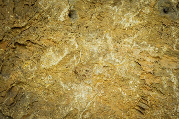 Light brown rock texture. Mountain rough surface. Close-up.