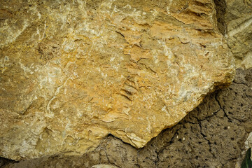 Light brown rock texture. Mountain rough surface. Close-up.