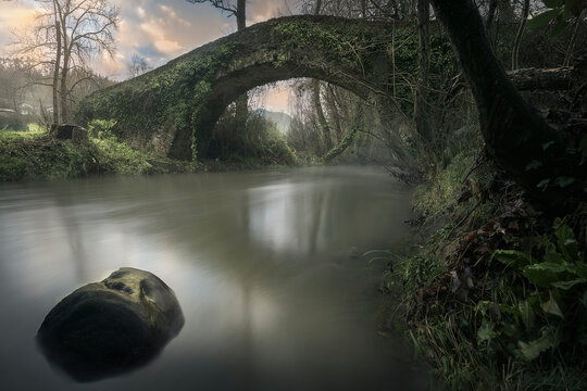 Sunrise over the Medieval Laiseka bridge over the Barbadun river that separates Sopuerta from Galdames