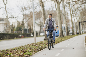 Fototapeta premium Man Riding Bike Down Bicycle Lane