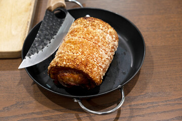 Crispy pork chashu in a pan on a wooden table
