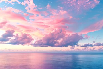 Fototapeta na wymiar Cirrus clouds tinted pink by the sun at sunset over a calm blue ocean