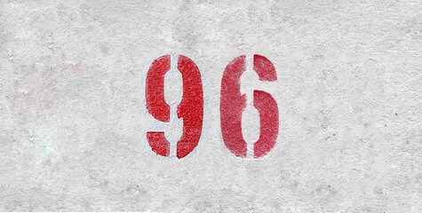Red Number 96 on the white wall. Spray paint.