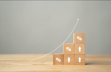 Concepts of interest rates and mortgage rates. Wooden block with percentage icon symbol and arrow...