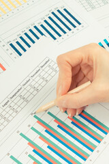 Pencil and financial chart showing production or sales statistics. Business