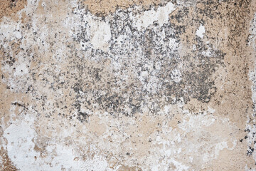 Cracked concrete wall covered with gray cement surface. Grey old wall with shabby damaged plaster...