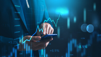 Investing and stock market concept. A businessman checks financial data charts for trading forex,...