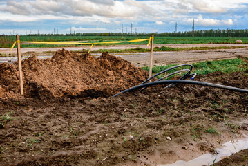 Laying a fiber optic cable for fast internet, electricity and telephone cable along a new street.