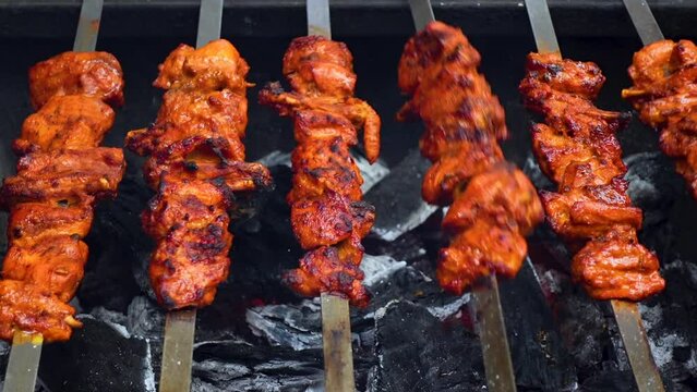 Seekh Kebab is being prepared on burning coals. Food recipe concepts.
