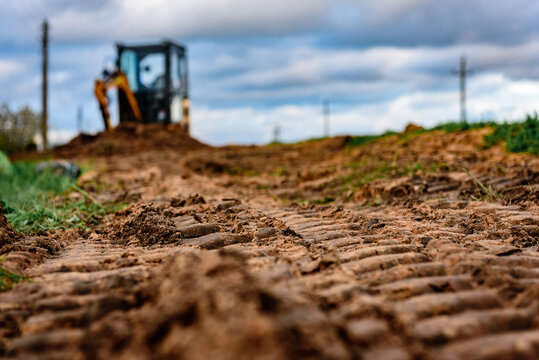 Laying a fiber optic cable for fast internet, electricity and telephone cable along a new street.