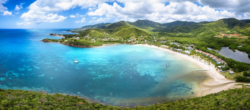 Panoramic aerial view of Carlisle Bay with lush rain forest and turquoise and emerald sea, Antigua and Barbuda, Caribbean