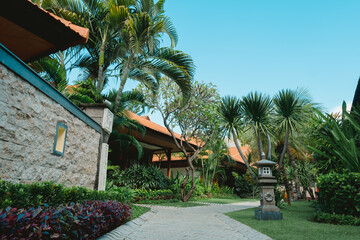Balinese resort with pavement pathway through tropical garden